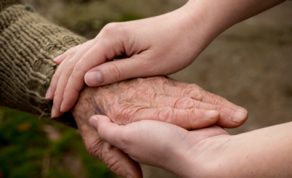 Research found BMI and gender are two major factors linked to high falls risk in residential aged care. Image: Adobe Elderly hand holding a youthful hand with greenery background